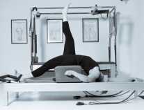 Client working on the reformer at Contrology Pilates studio, Sydney